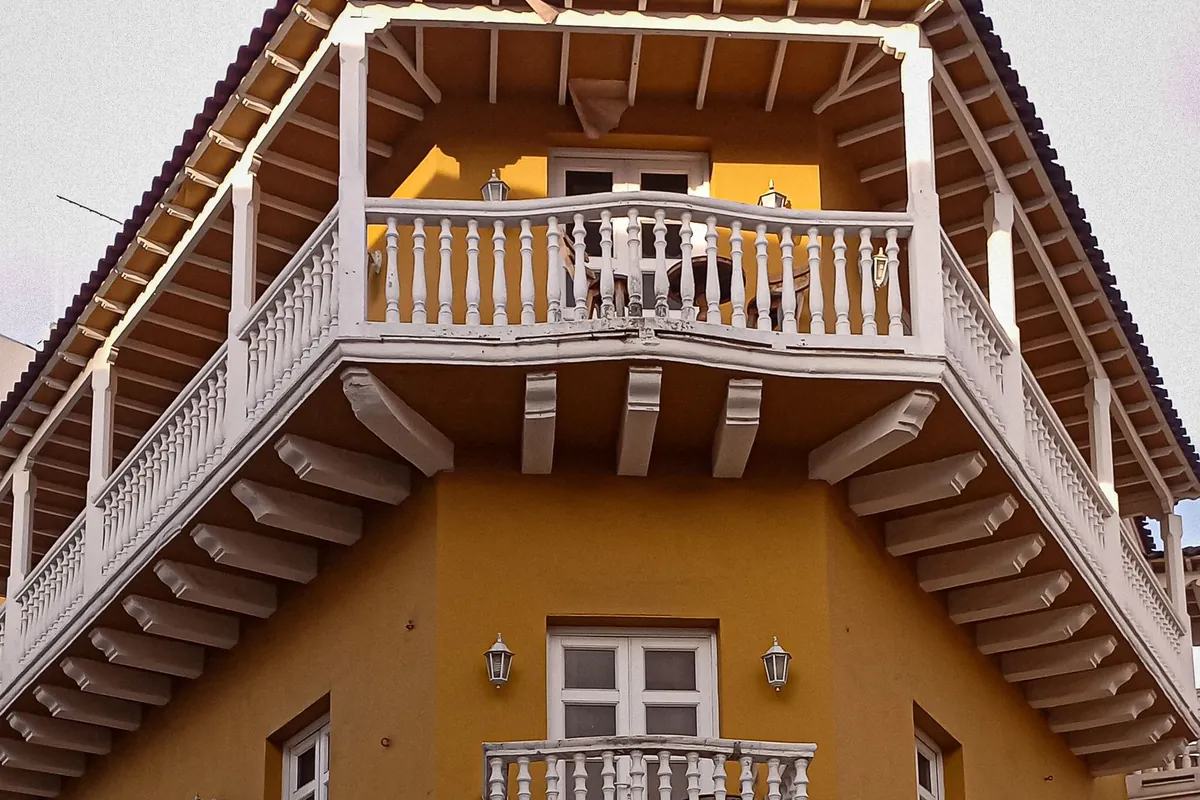 Yellow colonial facade and wooden balconies in Cartagena